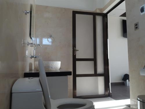 a bathroom with a toilet and a sink at Hotel Cristales De Sal in Uyuni