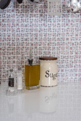 a bathroom counter with two bottles of oils on it at Etesians Suites & Villas in Super Paradise Beach