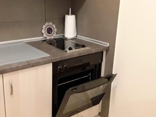 a kitchen with a stove and a counter with a candle at Lion Apartment Sunset in Thessaloniki