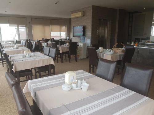 a dining room with tables and chairs in a restaurant at Kent Hotel in Samsun
