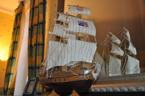 a model of a pirate ship on a wall at Château Logis de Roche in Clairac