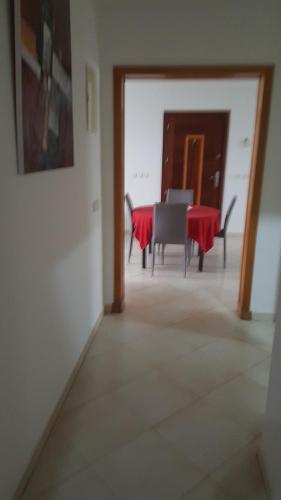 a dining room with a red table and chairs at Residence les Pins in Rabat