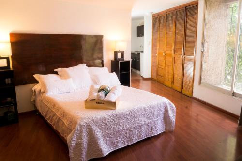 a bedroom with a bed with a box on it at Suite 1C, Balcon, Garden House, Welcome to San Angel in Mexico City