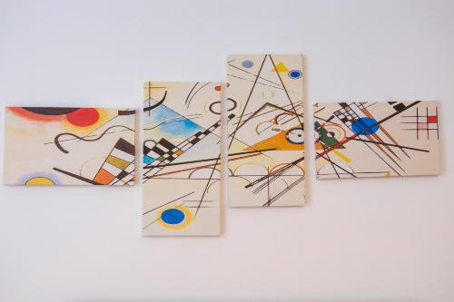 four pieces of abstract painting on a wall at Enjoy Trani in Trani