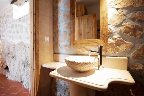 a bathroom with a stone sink and a mirror at Anemos in Koríthion