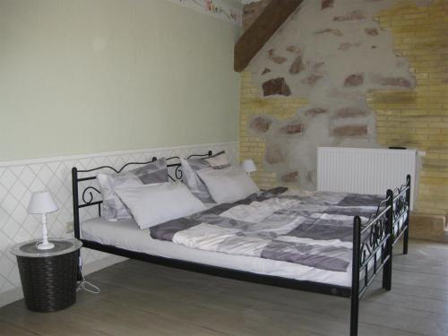 a bedroom with a bed in a room with a wall at Pension Casa Luciko in Brachwitz