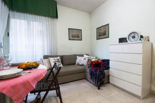 a living room with a couch and a table at Asher's House Colosseum in Rome