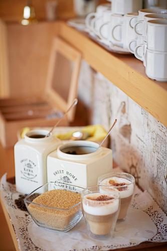 a table topped with cups of coffee and bowls of food at Złociste Zacisze in Bobolin