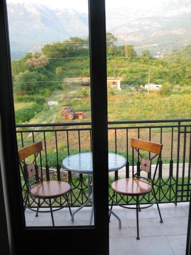 two chairs and a table on a balcony with a view at Apartments Ivetić in Kotor