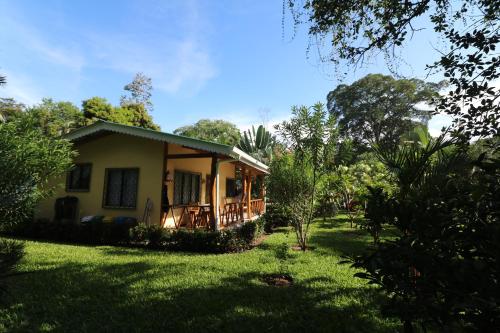 a small house with a porch in a yard at New Caribe Point in Cahuita