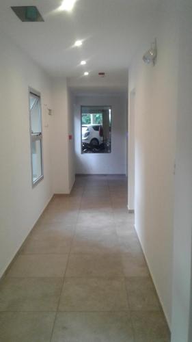 an empty hallway with a car in a window at Tu Espacio in La Plata