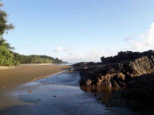 a view of a beach with rocks and water at Las Brisas del Sur in Ojochal