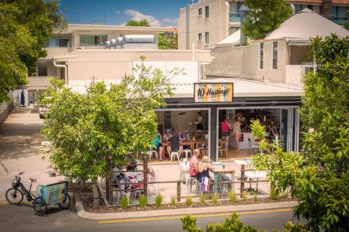 people sitting at tables outside of a restaurant at 10 Hastings Street Motel in Noosa Heads