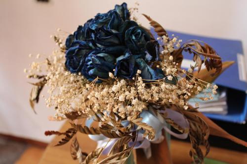 un bouquet bleu de fleurs dans un vase dans l'établissement Hotel Il Santuario - Pompei, à Pompéi