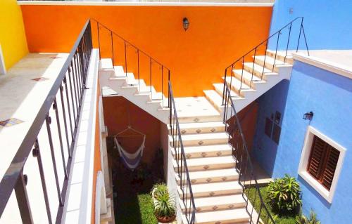 a staircase leading up to a building with plants at Merida Santiago Hotel Boutique in Mérida