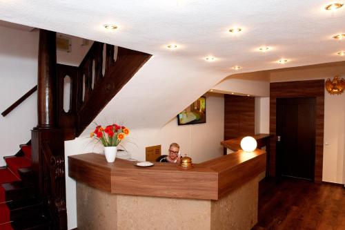a man sitting at a bar in a house at Hotel Adler in Eichstätt