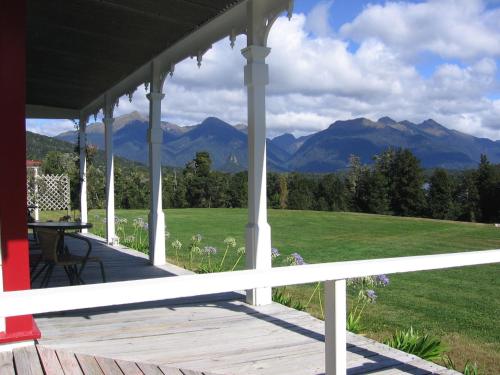 a porch with a view of mountains at Murrells Grand View House in Manapouri