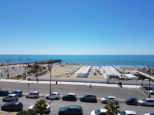 a parking lot with cars parked on the beach at Hotel La Scaletta in Lido di Ostia