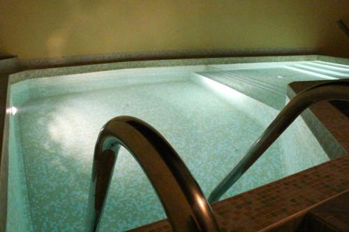 a pool of water with a metal railing in it at Hotel Radik in Sozopol