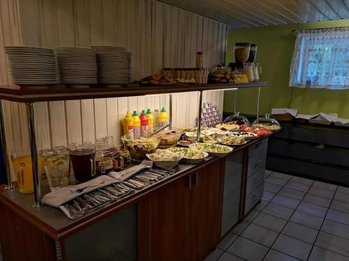 a buffet line with food and drinks in a kitchen at Hotel Kakadu in Konin
