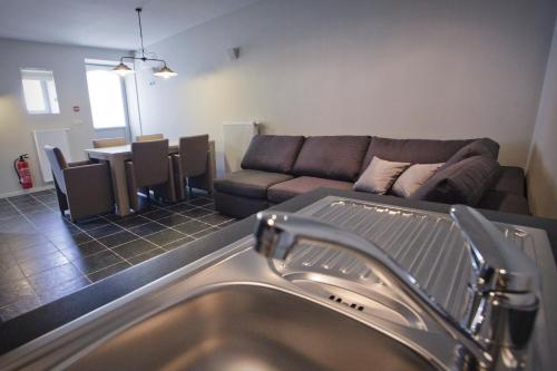 a living room with a couch and a sink at B&B De Oude Winning in Riemst