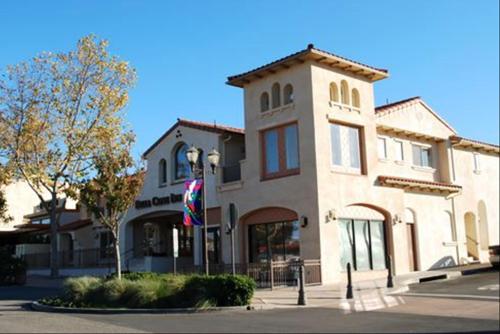 a large building with a flag in front of it at Bella Capri Inn and Suites in Camarillo