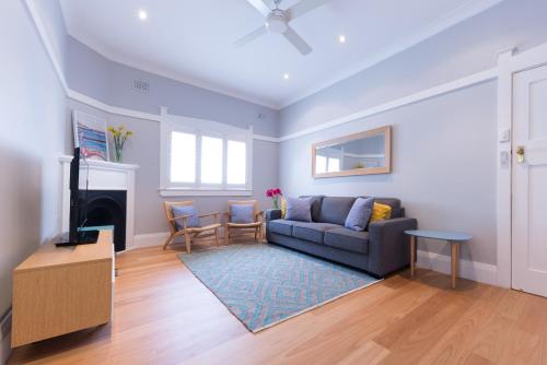 a living room with a couch and a fireplace at Beach Retreat in Sydney