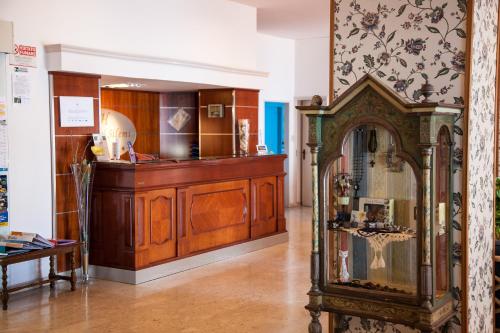 a room with a grandfather clock in a museum at Park Hotel Silemi in Letojanni