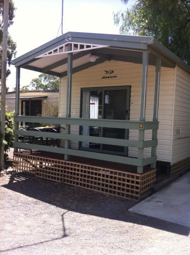 a house with a porch on top of it at Golden Country Motel and Caravan Park in Maryborough