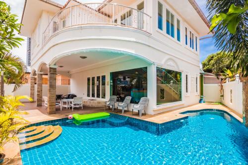 a villa with a swimming pool and a house at TEWAREE VILLA - PATTAYA HOLIDAY HOUSE WALKING STREET 4 bedrooms in Pattaya South