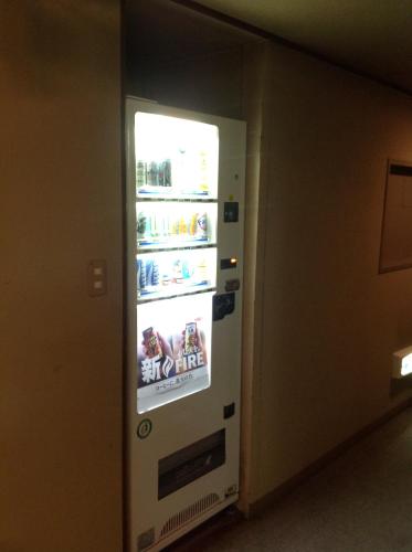 a refrigerator with an open door in a room at Nakayasu Ryokan in Kanazawa