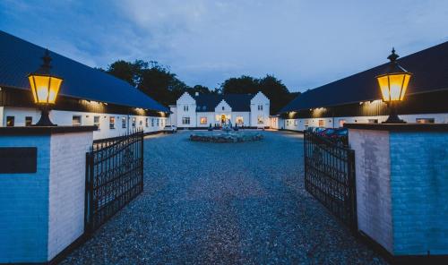 a building with a gate with lights on it at Gørdinglund Herregård Bed & Breakfast in Gørding