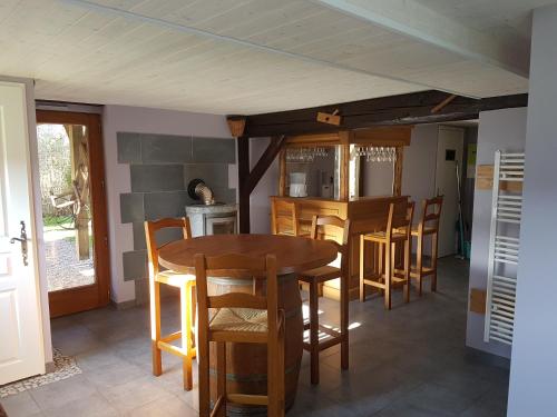 a kitchen with a wooden table and chairs at spa et wellness in Xonrupt-Longemer