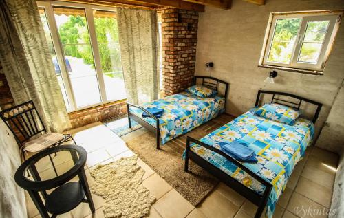a room with two beds and a window at Rusnietis in Rusnė