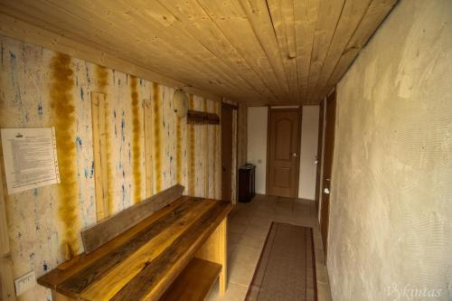 a room with a wooden bench on the wall at Rusnietis in Rusnė