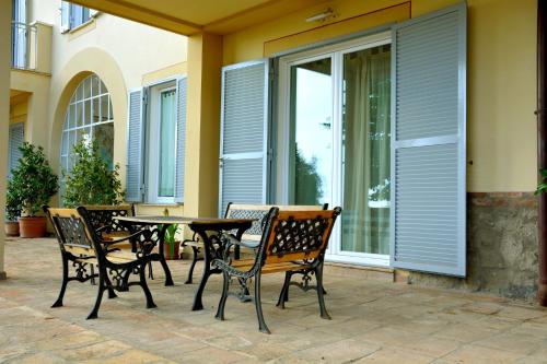 a patio with a table and chairs on a patio at Casale Del Gelso in Genzano di Roma