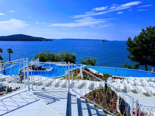a swimming pool with a view of the water at Mobile Homes Danijela in Amadria Park Trogir in Seget Vranjica