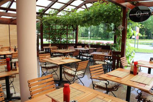 an empty restaurant with wooden tables and chairs at Guesthouse Veranda in Mojstrana