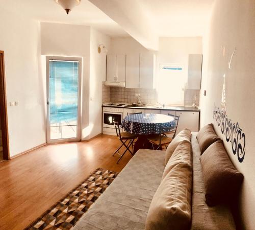 a living room with a couch and a table at Villa Toni in Sveti Filip i Jakov