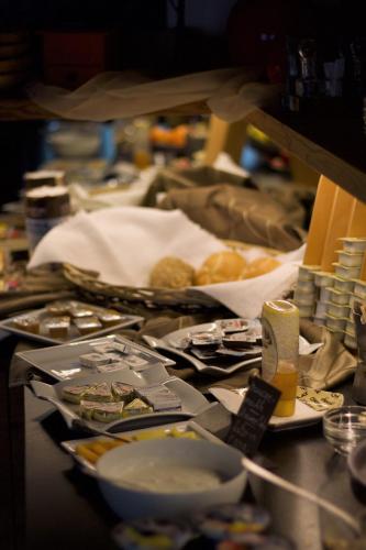 a table topped with plates of food on top at Cafe Schneider in Lappago