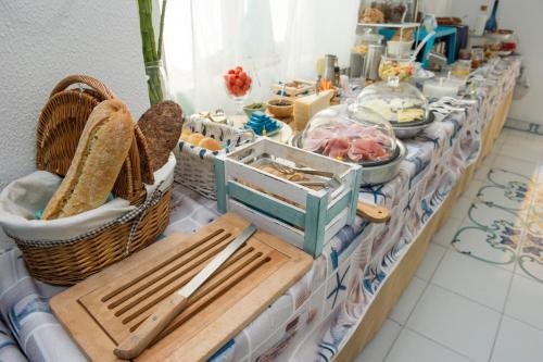 a table with baskets and other items on it at Hotel Punto Verde in Marina di Campo