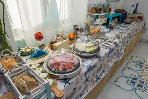 a table with many plates of food on it at Hotel Punto Verde in Marina di Campo
