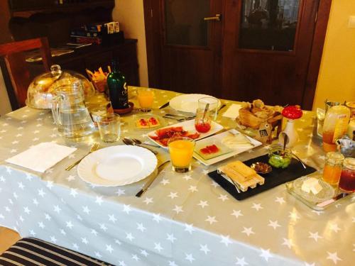 ein Tisch mit Tellern voller Essen darauf in der Unterkunft Casa Salto de Roldán in Apiés