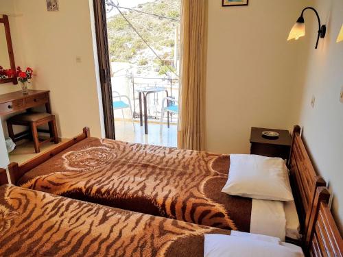 a bedroom with a bed with a tiger print blanket at Kalypso in Agia Galini
