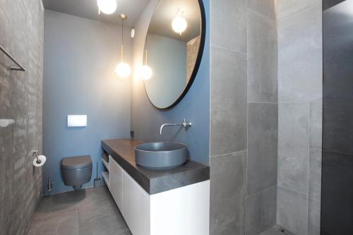 a bathroom with a sink and a mirror at Ocean View Luxury Apartment in Central Reykjavik in Reykjavík