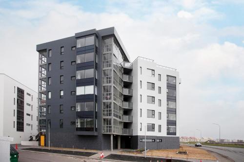 a large white building on the side of a road at Ocean View Luxury Apartment in Central Reykjavik in Reykjavík