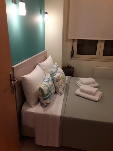 a small bed with pillows and towels on it at Lion Apartment Sunset in Thessaloniki