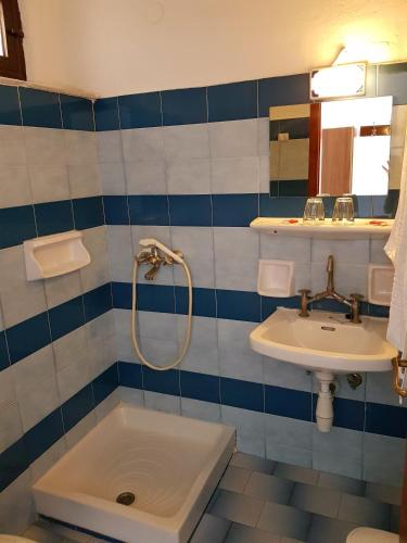 a bathroom with a shower and a sink and a tub at Kalypso in Agia Galini