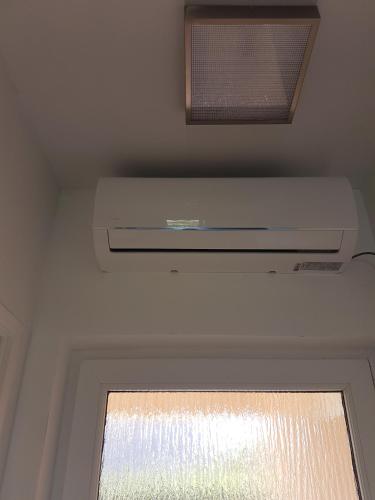 a window in a room with a ceiling fan at Studio apartment Laura || in Murter