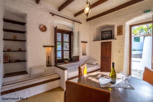 a room with a table with a bottle of wine at Villa Bella Leros in Agia Marina